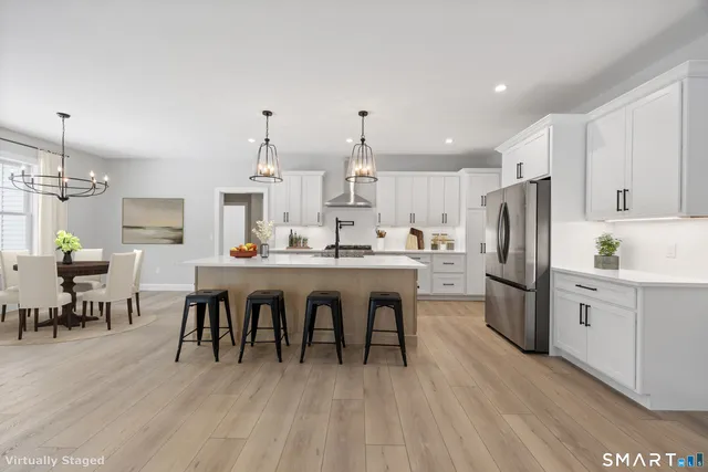 a large kitchen with a table and chairs