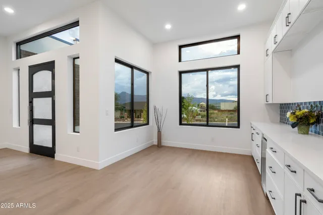 a kitchen with granite countertop white cabinets and refrigerator