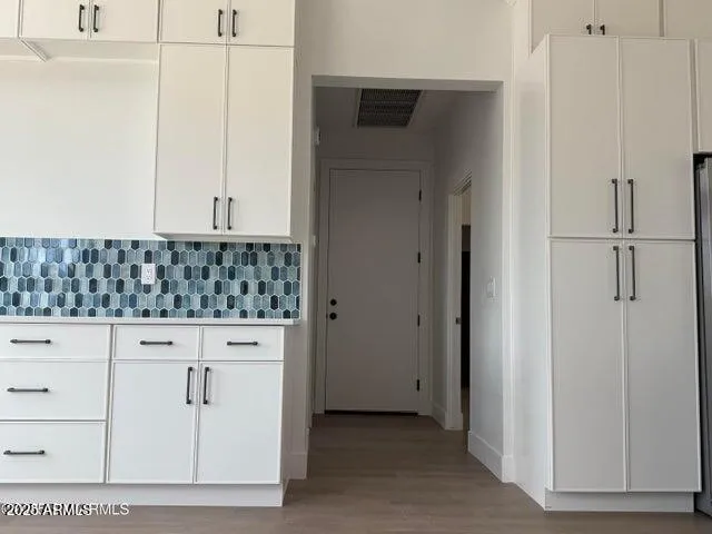 an empty room with a ceiling fan and window