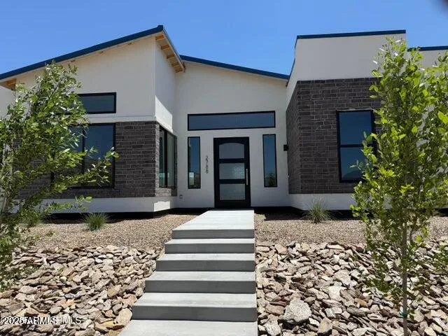 a view of a white house with a yard