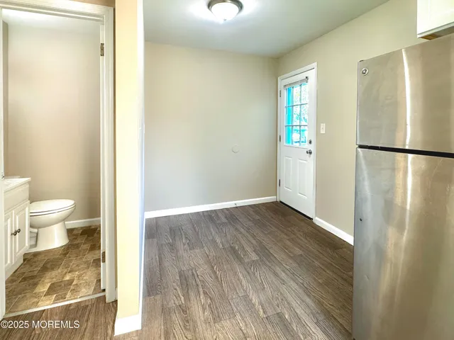 a bathroom with a sink a toilet and mirror