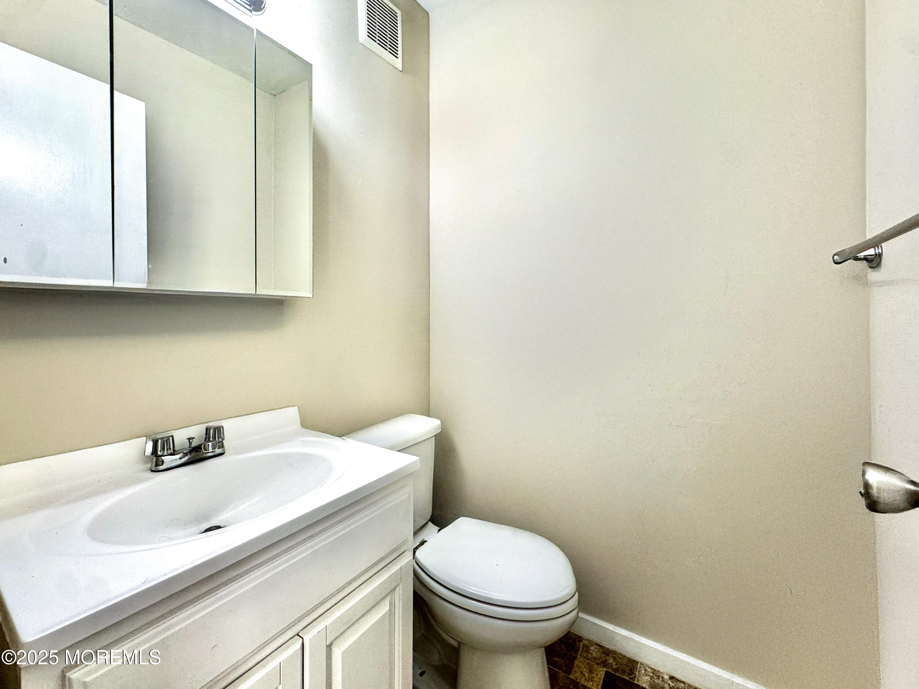 173 Primrose Lane Brick, NJ 08724 - Photo 13 of 24 a bathroom with a sink a toilet and mirror