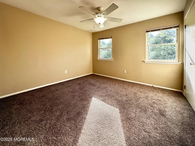 a bedroom with a bed and a flat tv screen on dresser