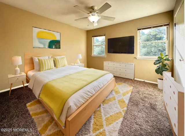 a view of an empty room and chandelier fan