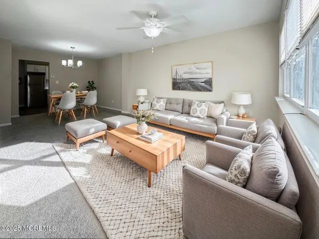 a living room with furniture and a chandelier
