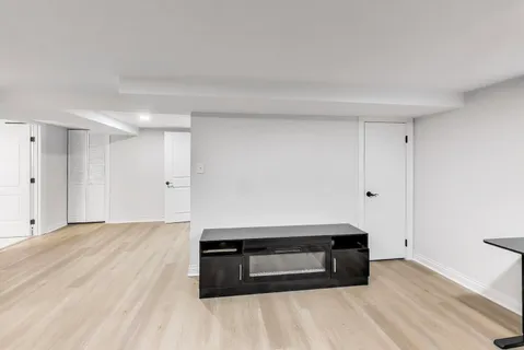 a room with a bench and a wooden floor