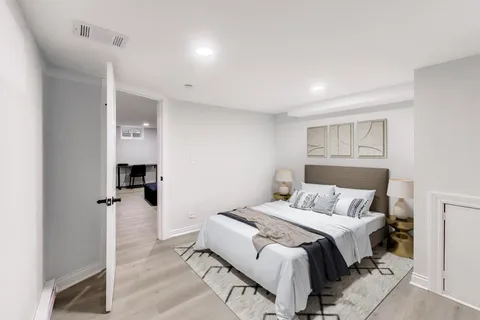 a bedroom with a bed and a lamp