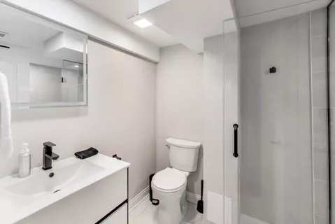 a bathroom with a toilet sink and mirror