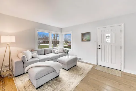 a living room with furniture and a lamp