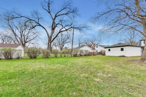 a view of a backyard with large trees