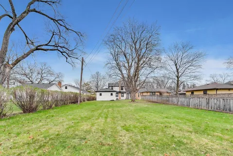a view of a backyard with a tree