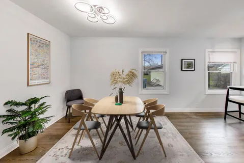 a dining room with furniture and wooden floor