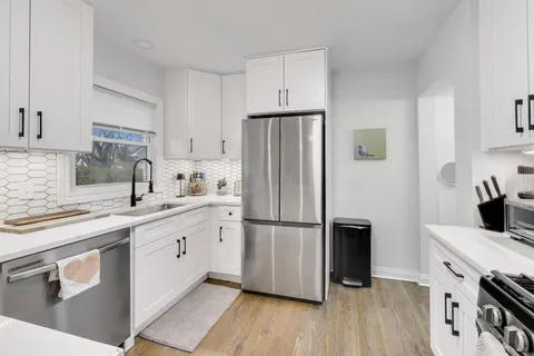 a kitchen with wooden cabinets and stainless steel appliances