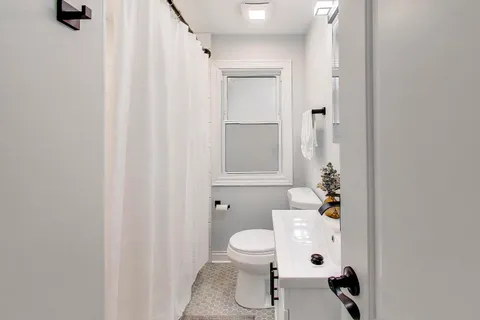 a bathroom with a sink toilet and shower
