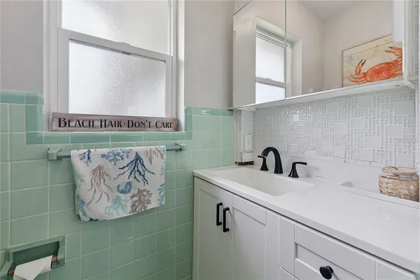 a bathroom with a sink and a mirror