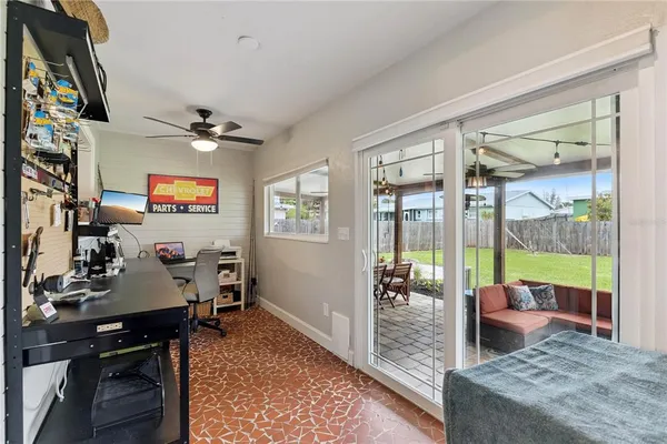 a living room with furniture and a floor to ceiling window