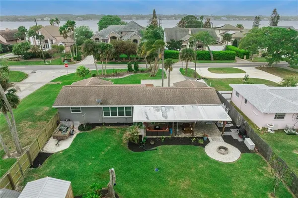 an aerial view of a house with a garden and a swimming pool