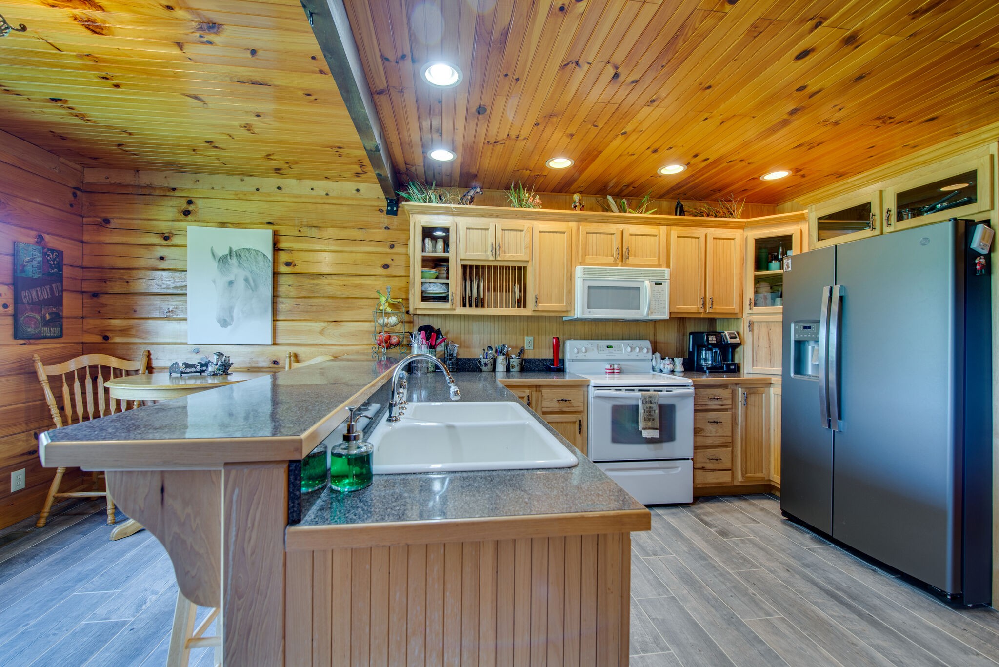 1946 Mann Road Lebanon, TN 37087 - Photo 24 of 50 a kitchen with stainless steel appliances granite countertop a sink a stove and a wooden floors