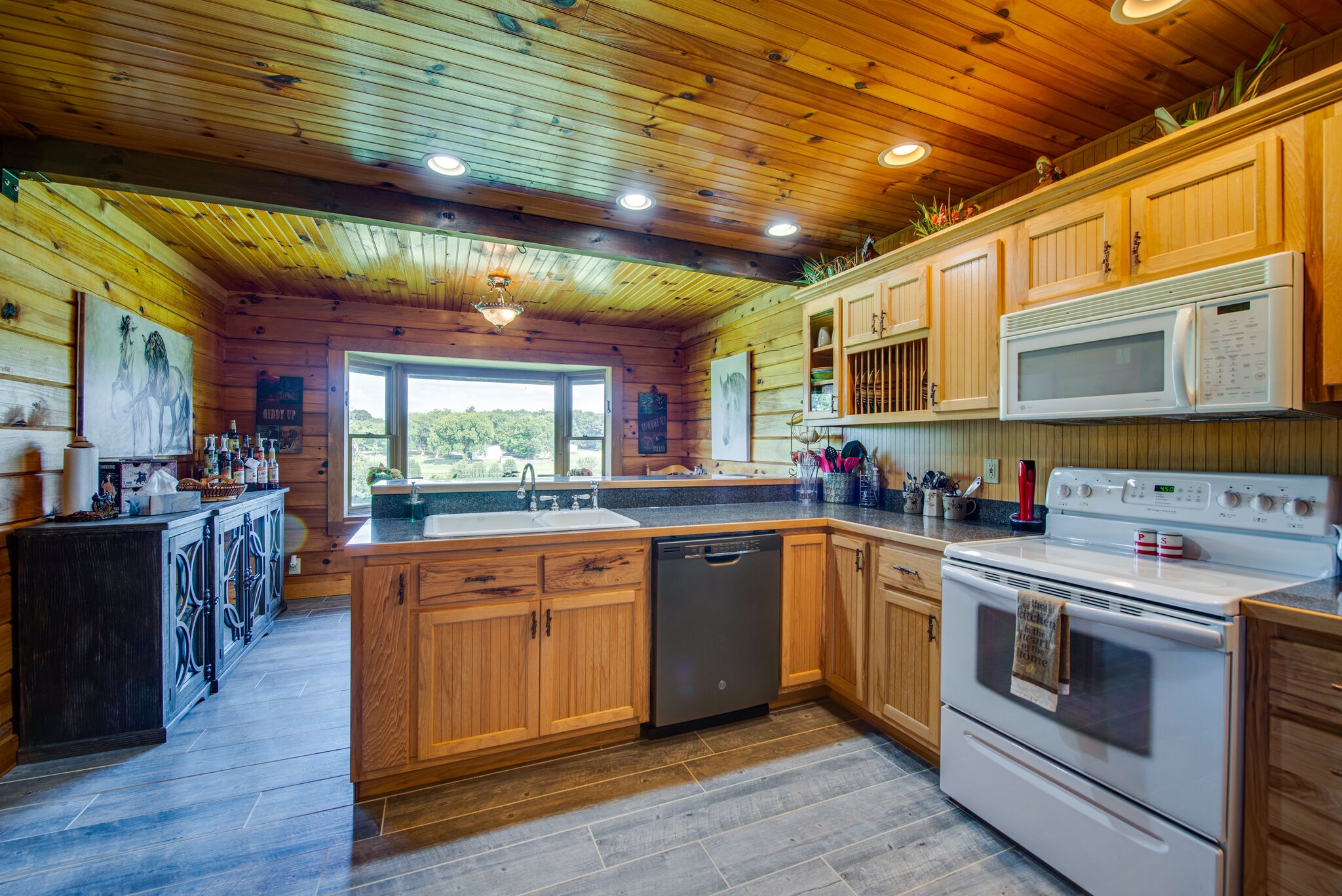 1946 Mann Road Lebanon, TN 37087 - Photo 25 of 50 a kitchen with stainless steel appliances granite countertop a stove a sink dishwasher and a microwave oven with cabinets