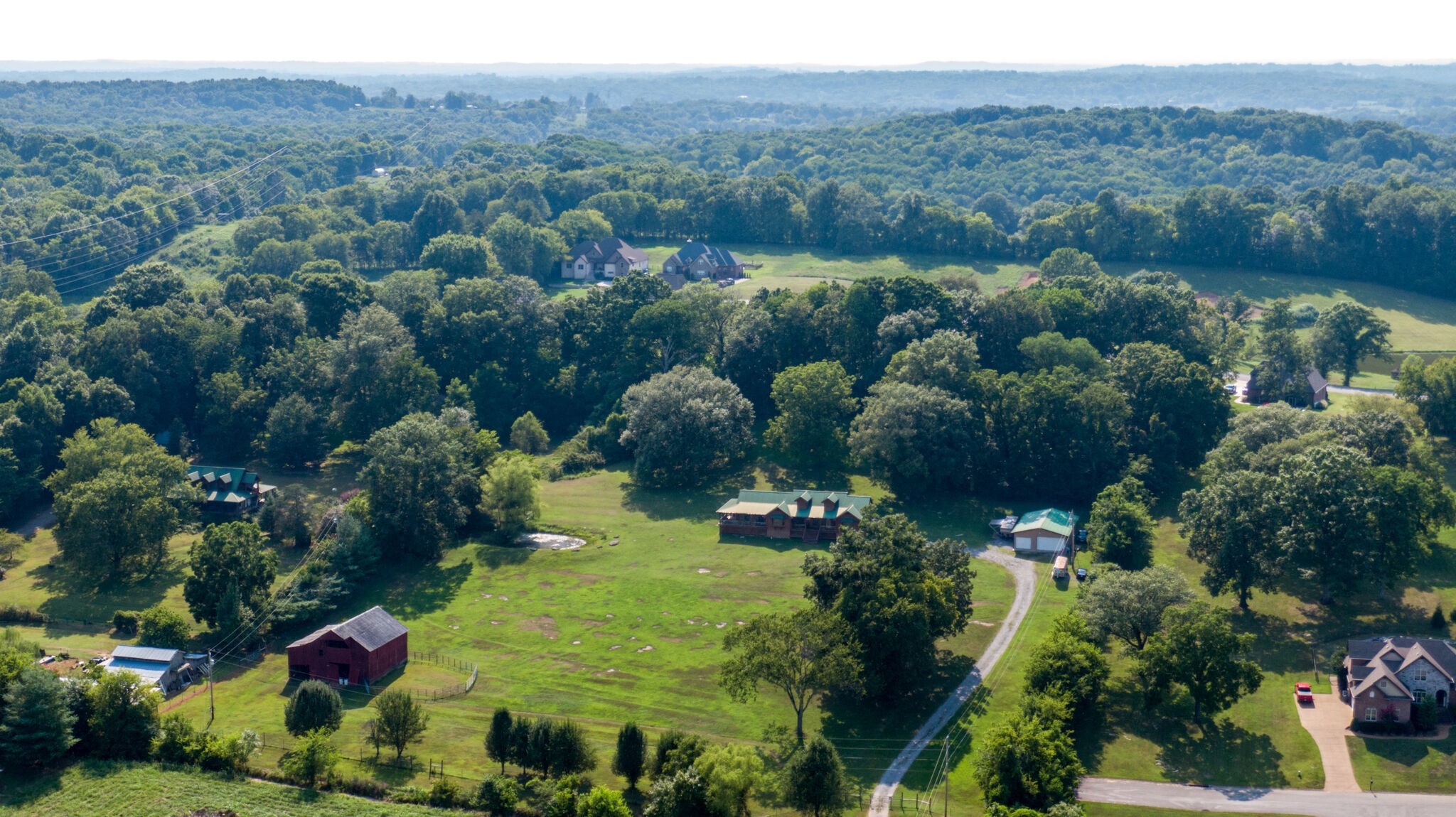 1946 Mann Road Lebanon, TN 37087 - Photo 5 of 50 an aerial view of green landscape with trees houses and mountain view