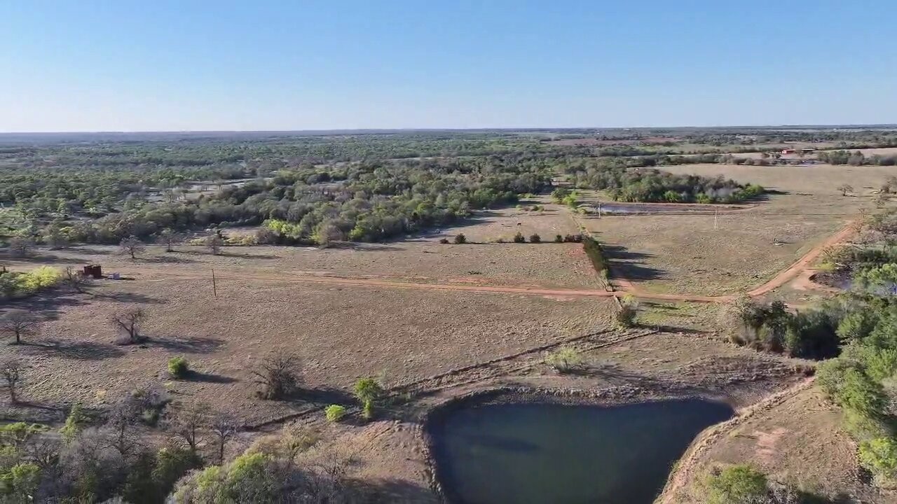 Tbd Lot 3 Tbd Road Paige, TX 78659 - Photo 2 of 15 a view of a dry yard with wooden fence