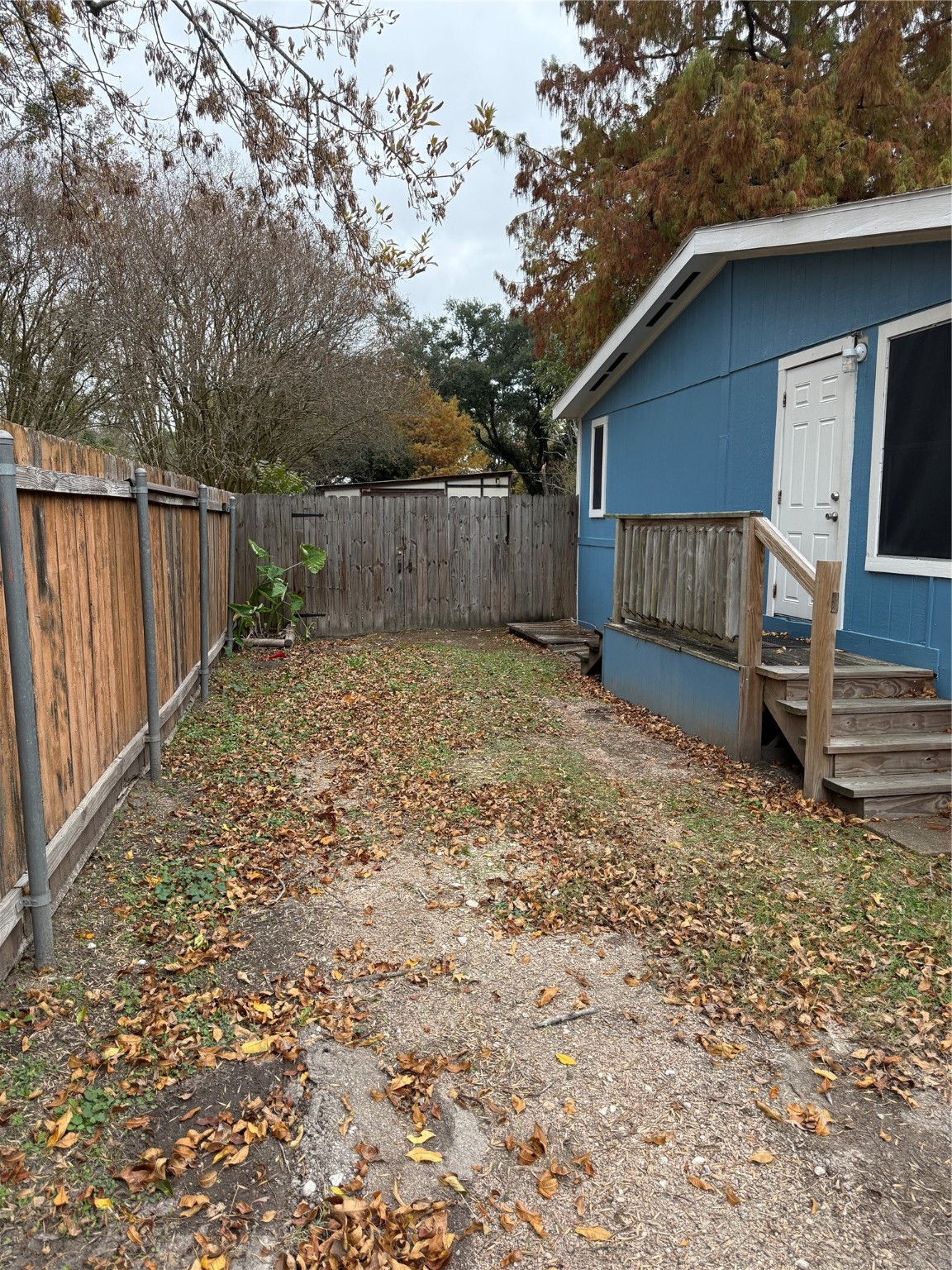2611 Lilac Street Pasadena, TX 77503 - Photo 30 of 30 a view of a house with a small yard and wooden fence