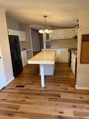 a view of a kitchen with wooden floor