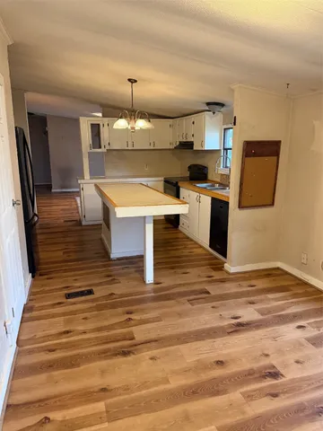a view of kitchen with sink microwave refrigerator and stove