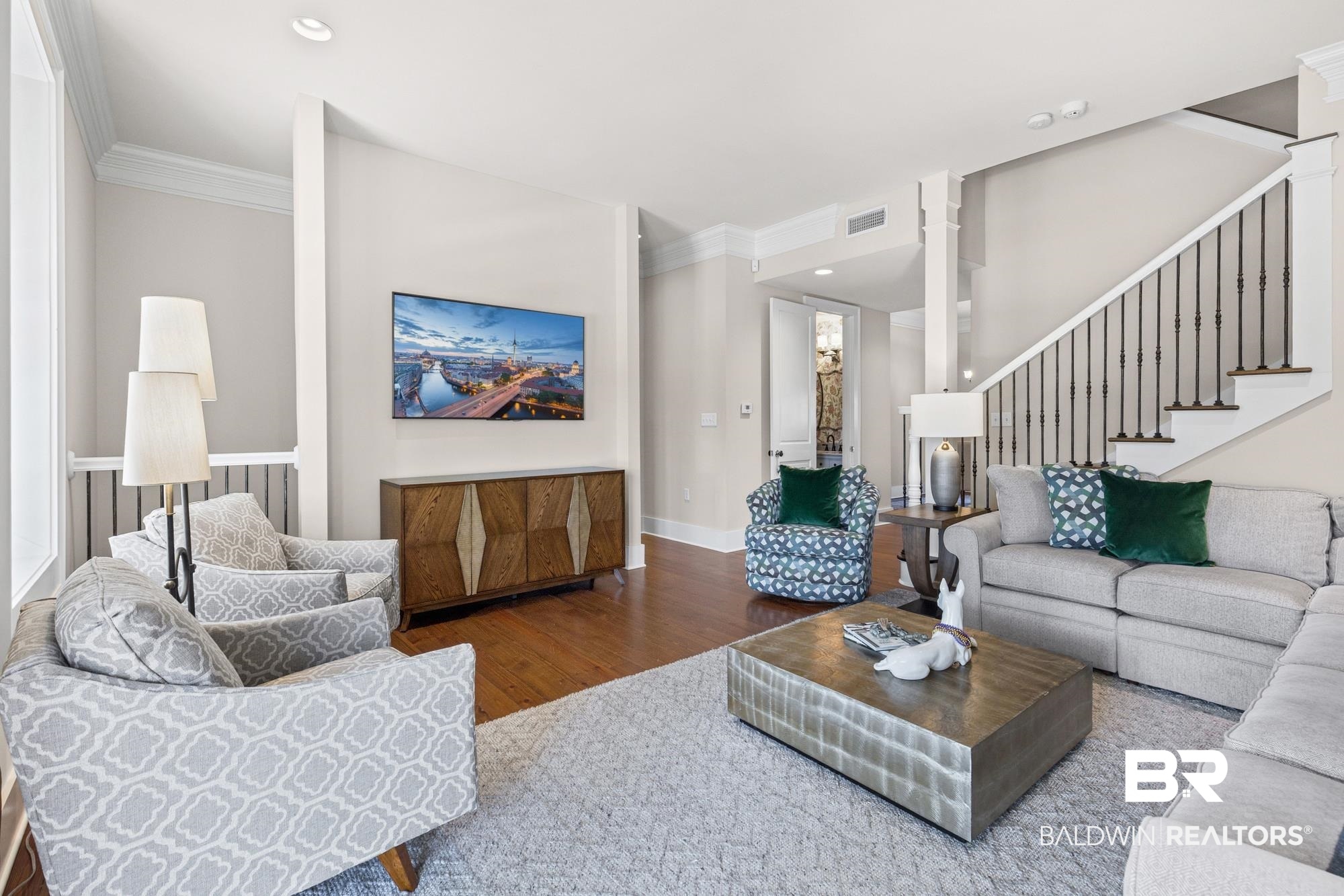 701 Dauphin Street, Unit A Mobile, AL 36602 - Photo 6 of 31 Living area featuring wood-finish flooring, recessed lighting, crown molding, and a staircase with decorative balusters