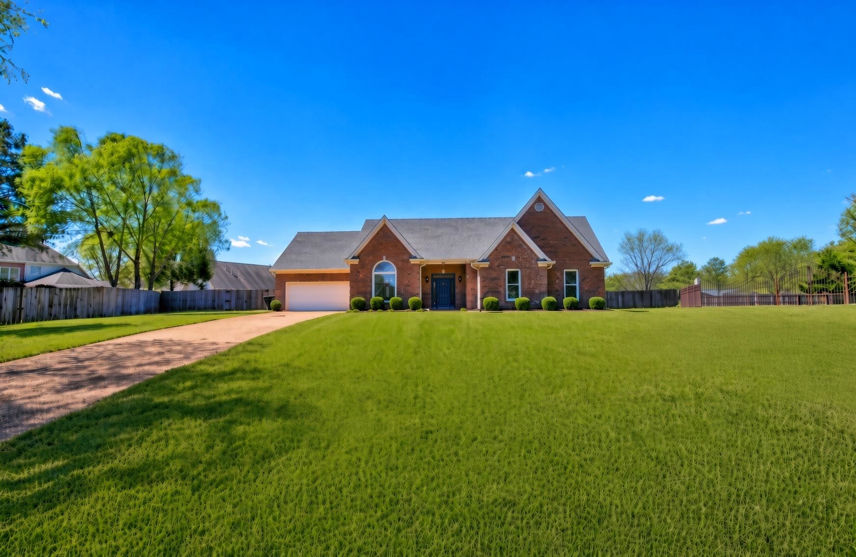737 Steeple Ridge Cove Collierville, TN 38017 - Photo 1 of 21 Brick exterior residence featuring a single-car garage, an arched window, a dark-colored front door, and a gravel driveway
