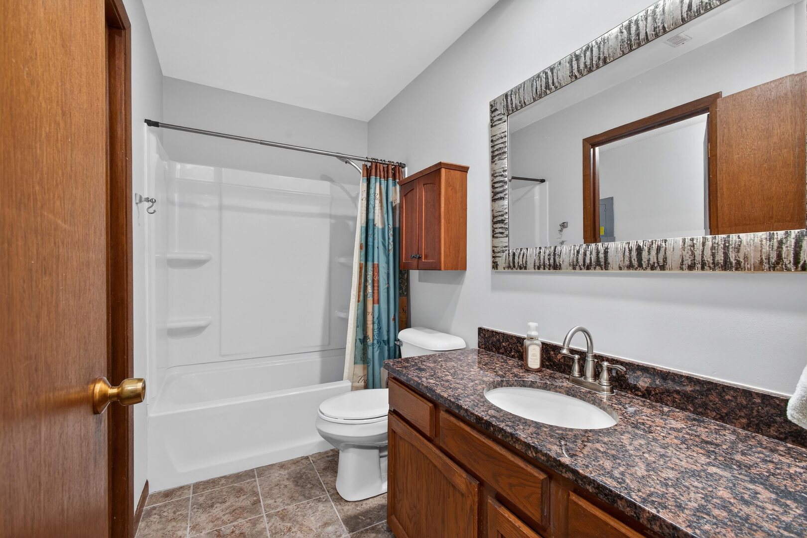 800 East Iowa Street, Unit 2C Eldridge, IA 52748 - Photo 16 of 28 a bathroom with a granite countertop sink toilet mirror and shower