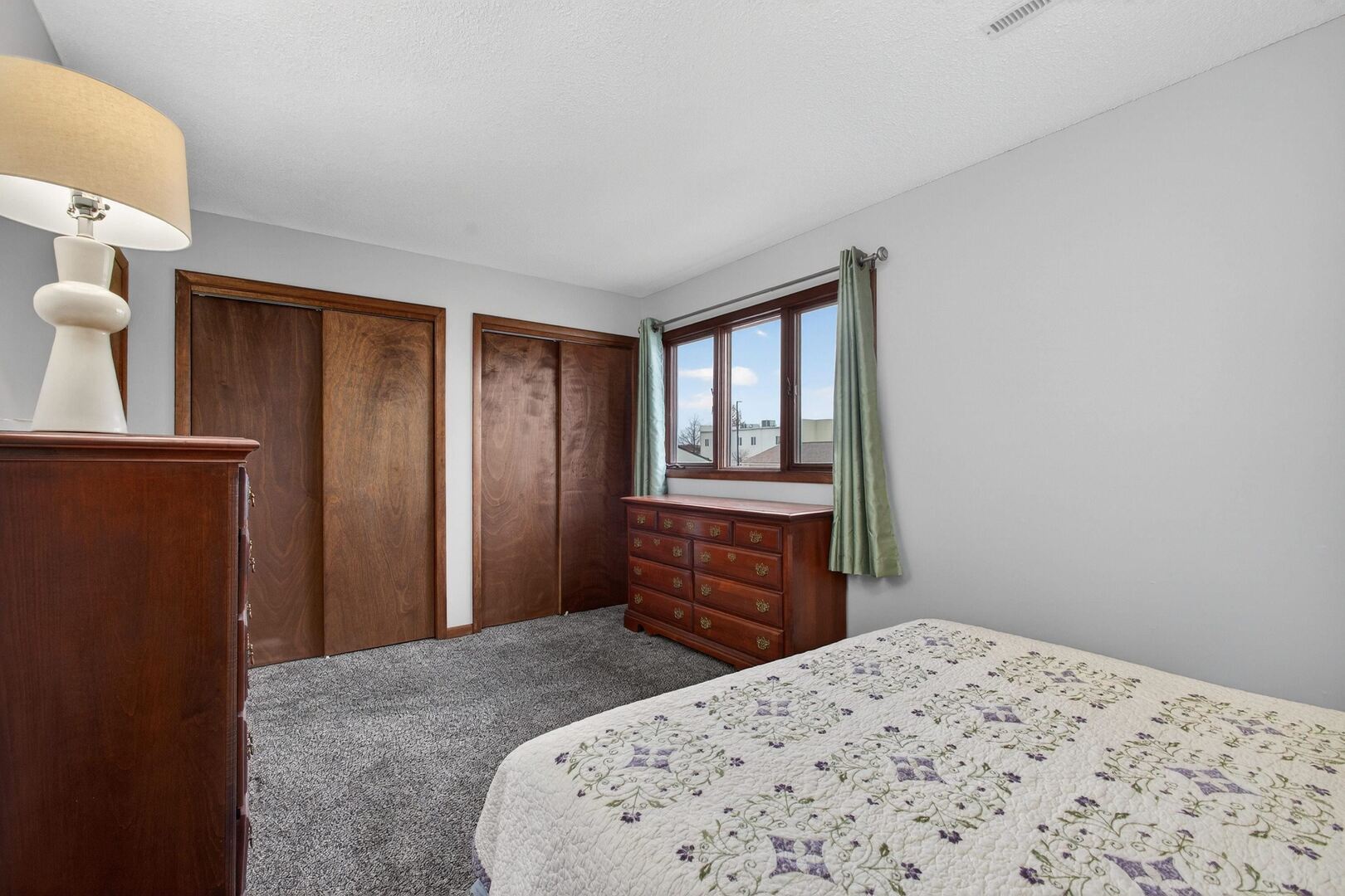 800 East Iowa Street, Unit 2C Eldridge, IA 52748 - Photo 23 of 28 a bedroom with a bed and a dresser