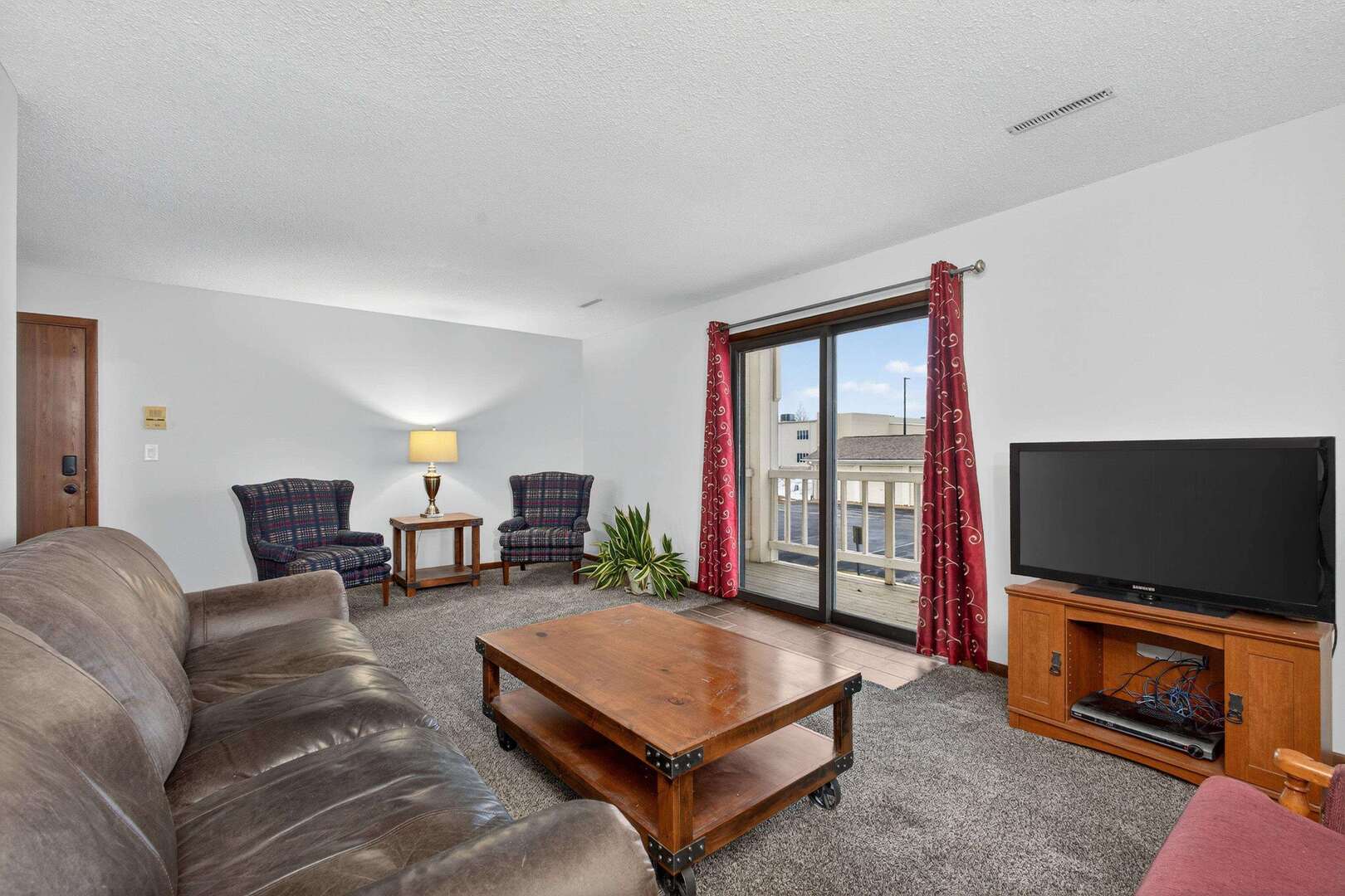 800 East Iowa Street, Unit 2C Eldridge, IA 52748 - Photo 6 of 28 a living room with furniture and a flat screen tv