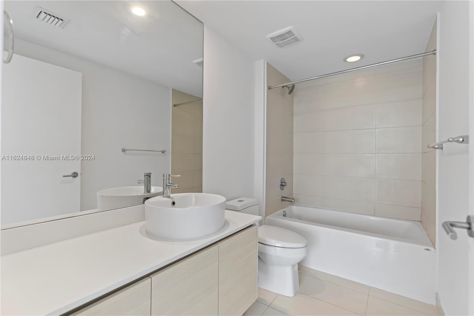 4250 Biscayne Boulevard, Unit 1018 Miami, FL 33137 - Photo 11 of 54 a bathroom with a sink a toilet and shower