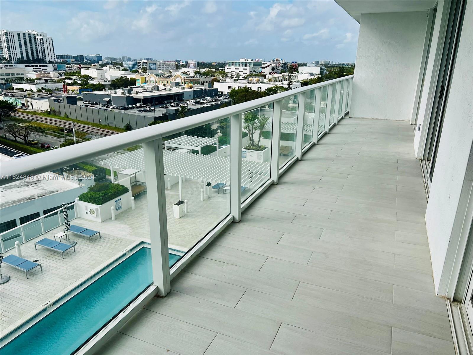 4250 Biscayne Boulevard, Unit 1018 Miami, FL 33137 - Photo 13 of 54 a balcony with an outdoor seating
