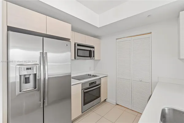 a kitchen with a refrigerator and a refrigerator