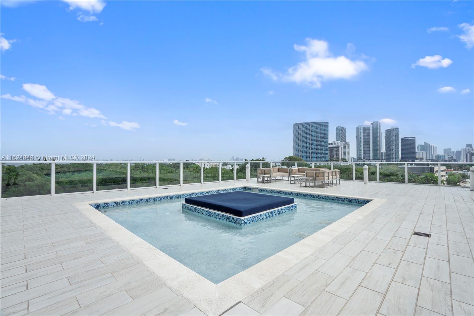 4250 Biscayne Boulevard, Unit 1018 Miami, FL 33137 - Photo 37 of 54 a view of a swimming pool and a back yard