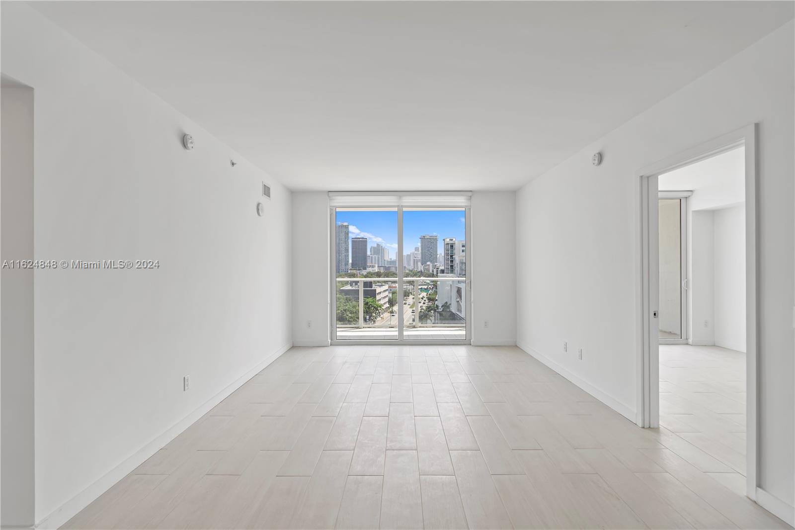 4250 Biscayne Boulevard, Unit 1018 Miami, FL 33137 - Photo 5 of 54 a view of a livingroom with a flat screen tv and a window