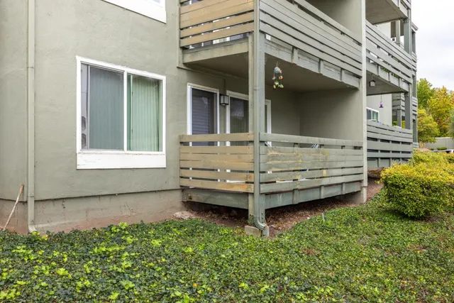 a view of a house with a balcony and a garden
