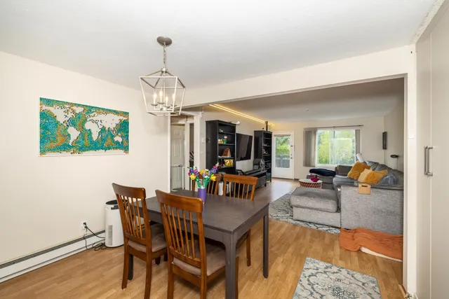a living room with furniture a chandelier and a flat screen tv
