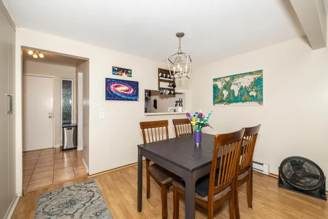 a view of a dining room with furniture wooden floor and a chandelier