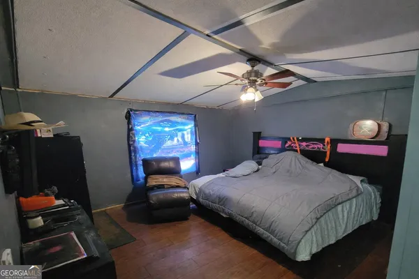 a bedroom with a bed and a mirror