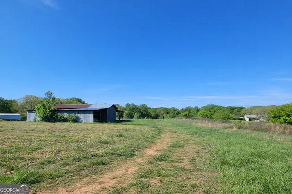 a view of a big yard with an outdoor space