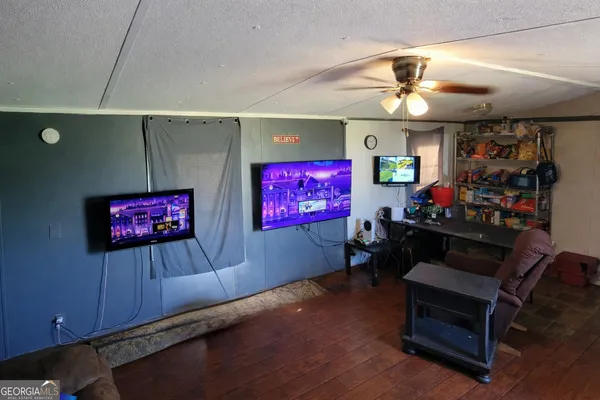 a living room with furniture gym equipment and a flat screen tv