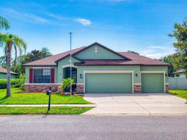 a front view of a house with a yard and garage