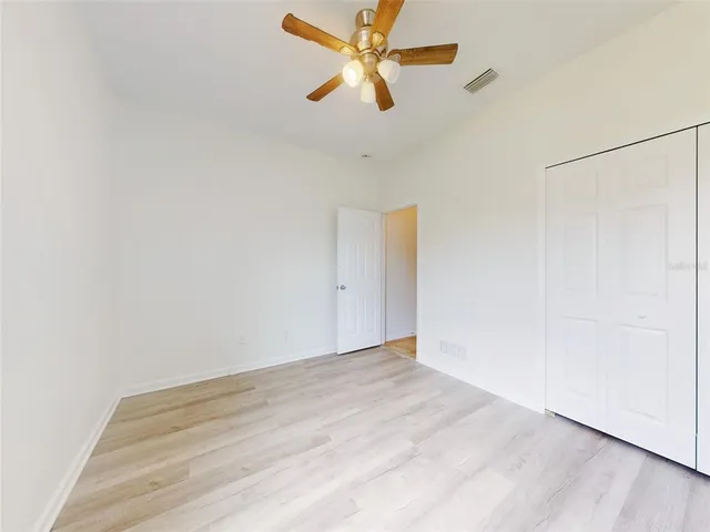 a kitchen with granite countertop white cabinets white stainless steel appliances with a sink and dishwasher