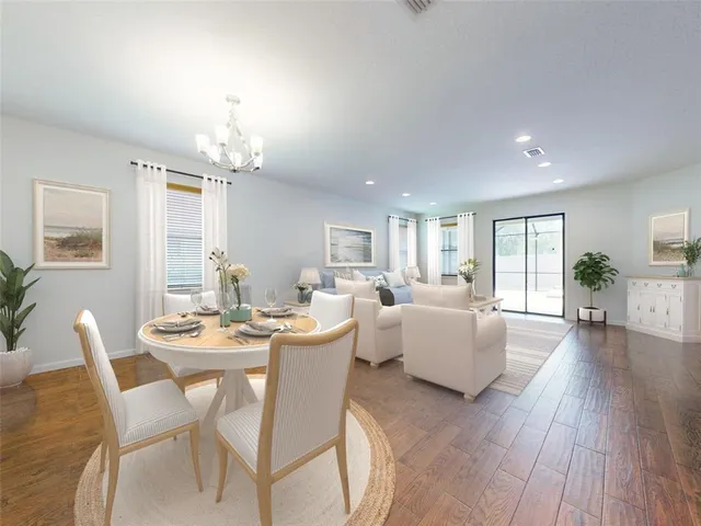 a dining room with wooden floor and furniture