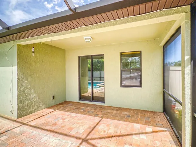 a view of a room with wooden floor and windows