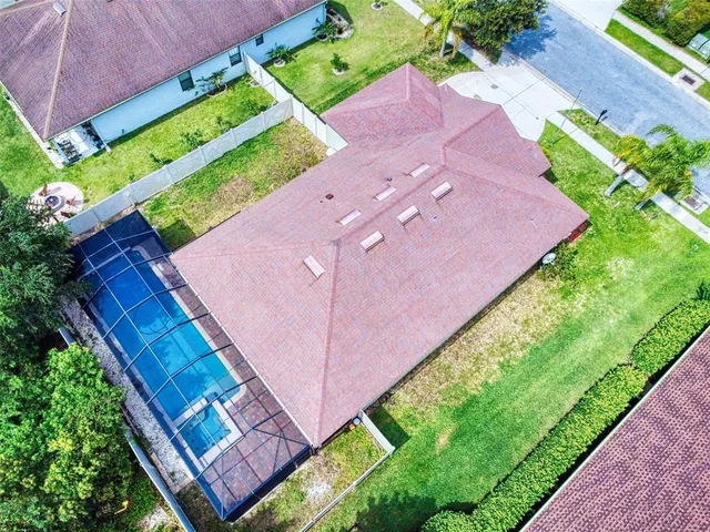 an aerial view of multiple houses with yard