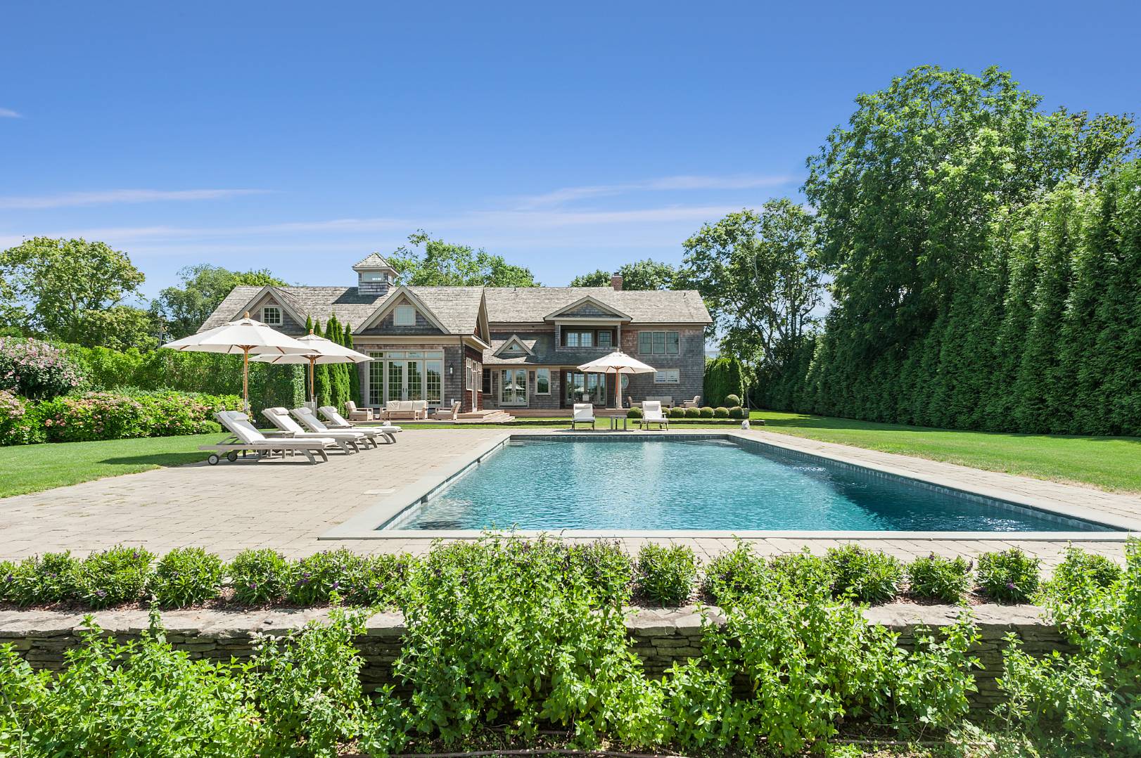 933 Cobb Road West Water Mill, NY 11976 - Photo 1 of 26 a view of a house with pool and sitting area